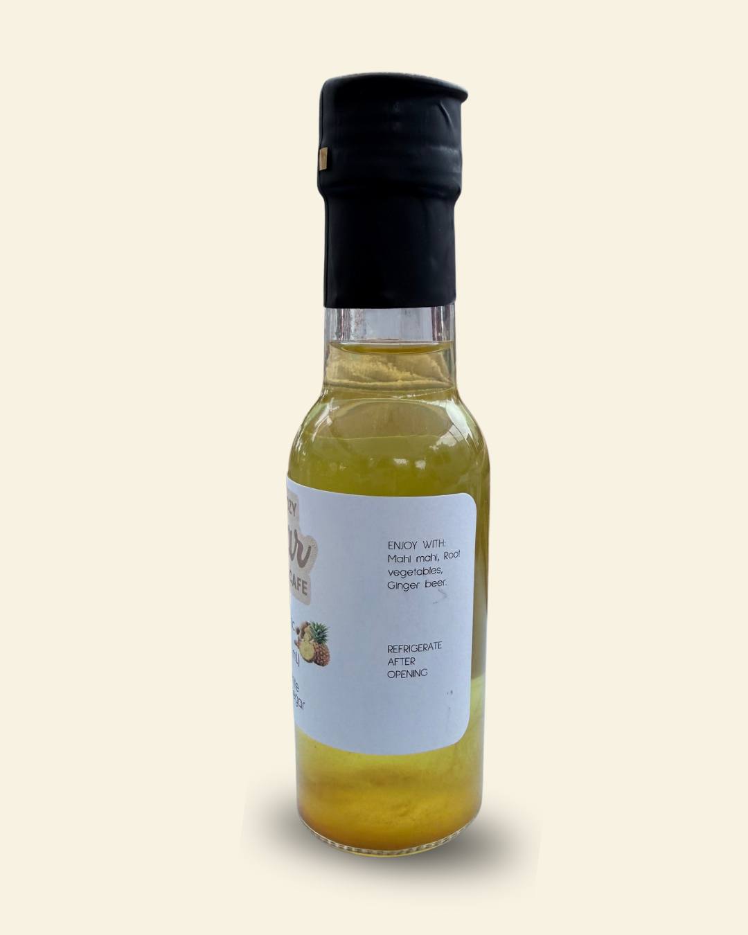 A bottle of Cozy Pear Cafe Glow Tonic, made from distilled white balsamic vinegar, featuring a white label and a black cap, set against a solid cream background.