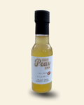 A 3 fl oz bottle of Cozy Pear Cafe Sol Spice Infused White Balsamic Vinegar, featuring a white label with brown script lettering and a black cap, set against a solid cream background.