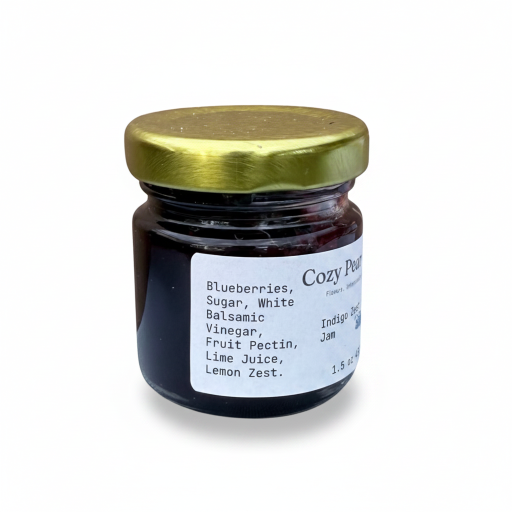 Cozy Pear Cafe Indigo Zest blueberry and citrus jam in a small glass jar with a gold lid
