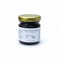 Cozy Pear Cafe Indigo Zest blueberry and citrus jam in a small glass jar with a gold lid on a white background