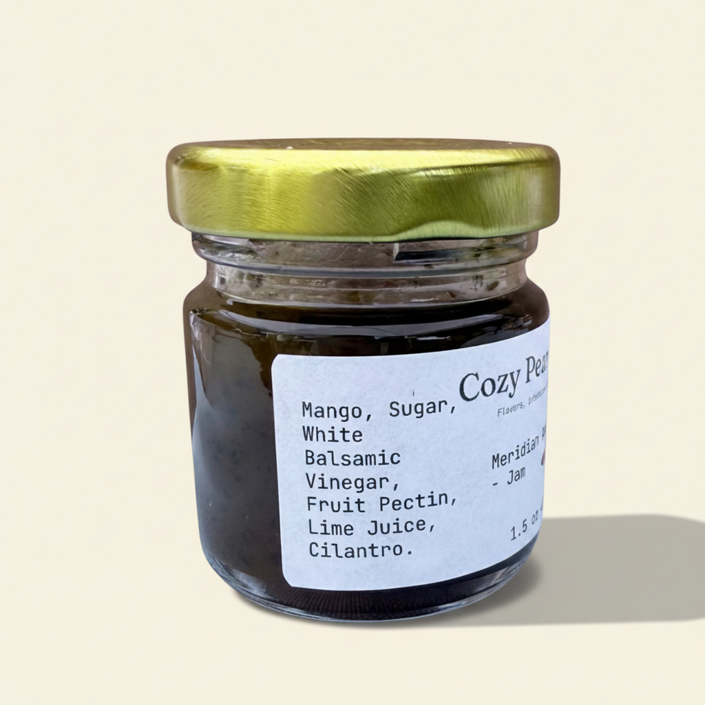 Cozy Pear Cafe Meridian Amber mango and white balsamic jam in a small 1.5 oz glass jar with a gold lid